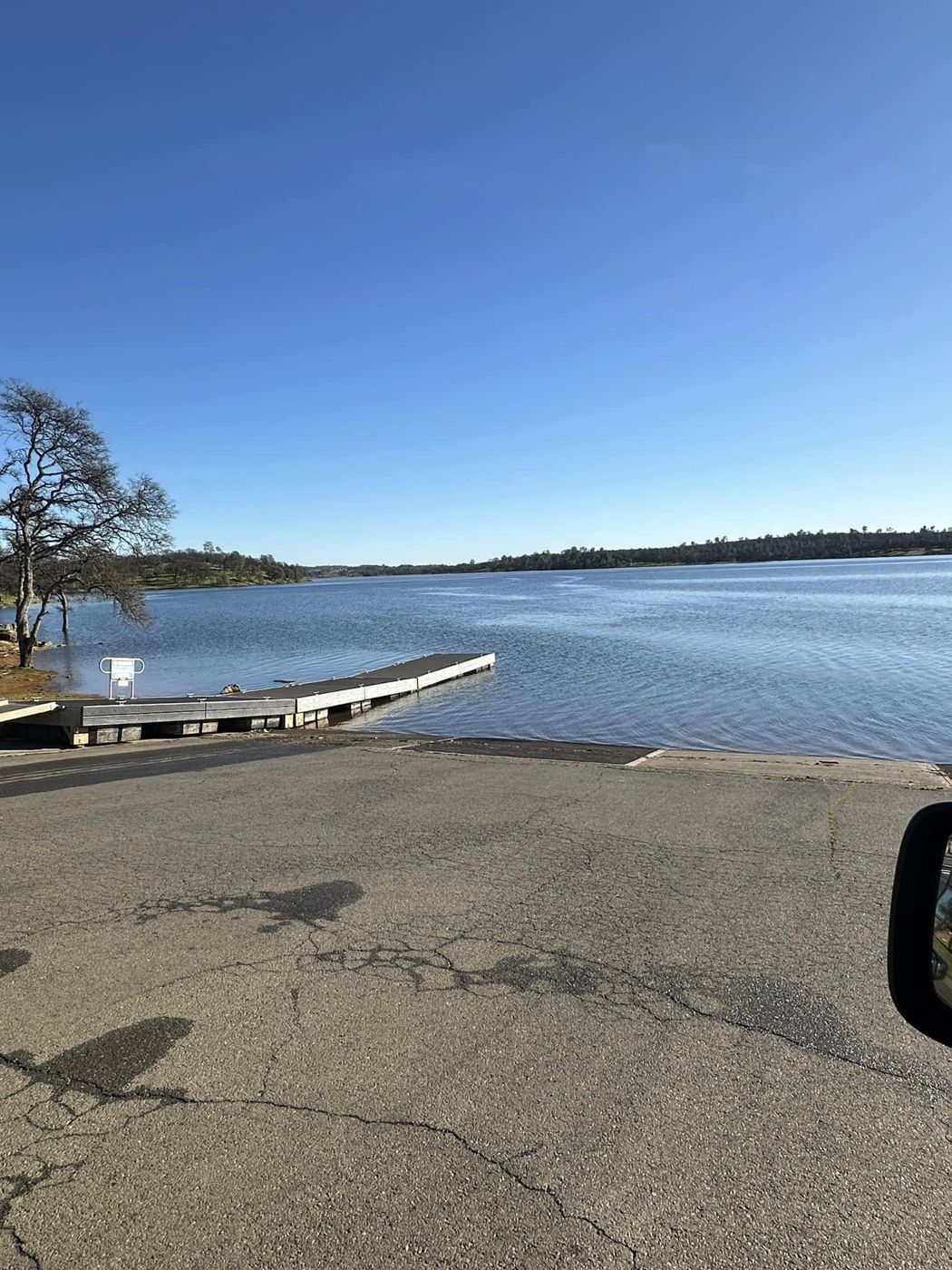 Boat ramp and dock under clear blue skies at Camp Far West Lake